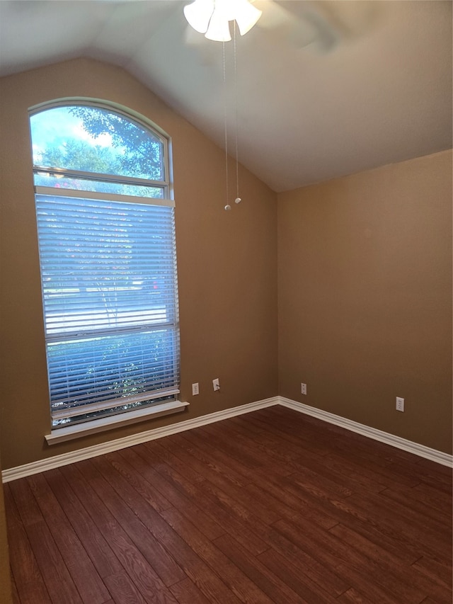 unfurnished room featuring vaulted ceiling, dark hardwood / wood-style floors, and ceiling fan