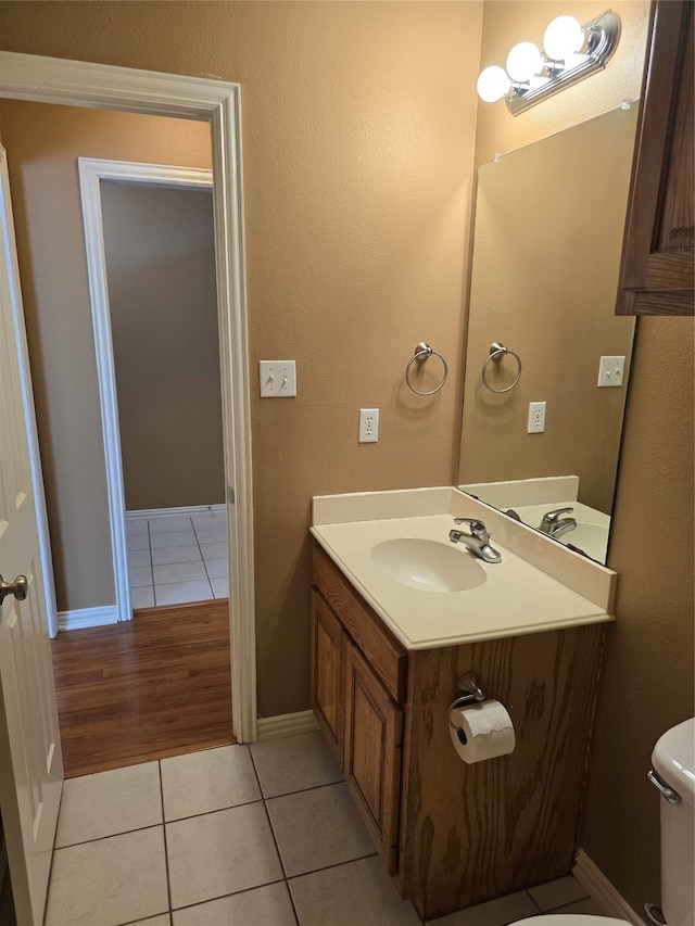 bathroom with vanity, toilet, and tile patterned floors