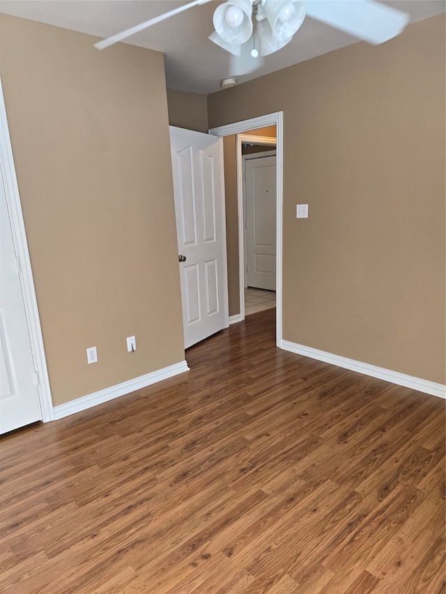 unfurnished room with ceiling fan and hardwood / wood-style floors