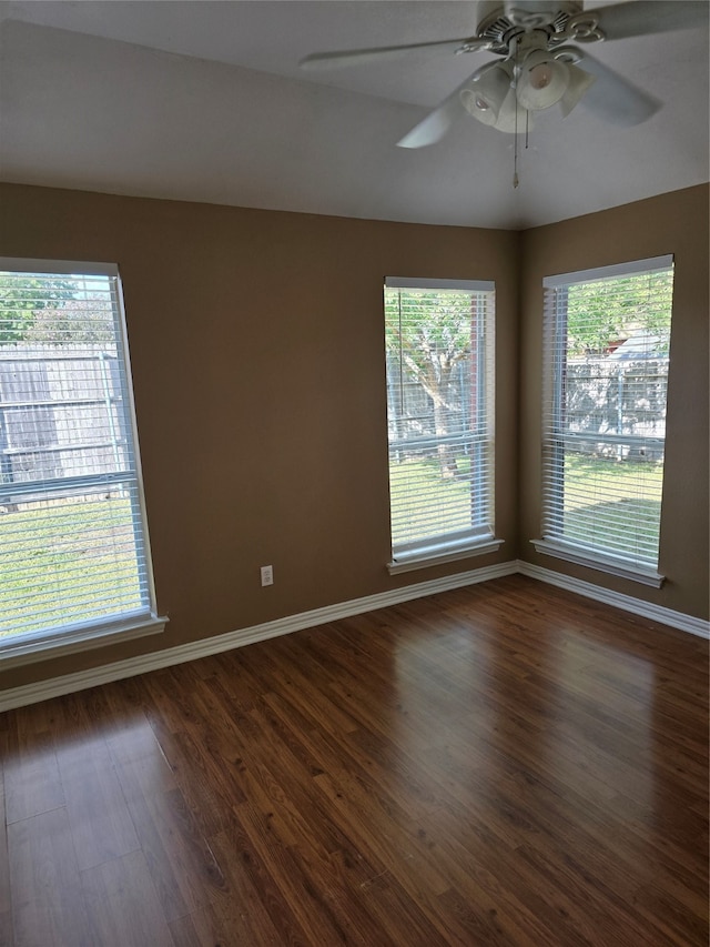 unfurnished room with dark wood-type flooring and ceiling fan