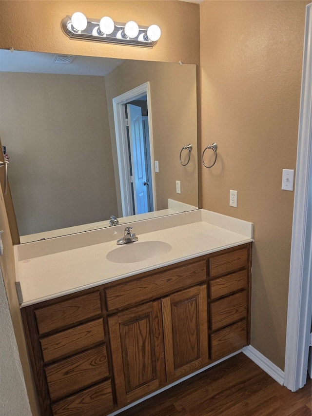 bathroom with vanity and hardwood / wood-style flooring