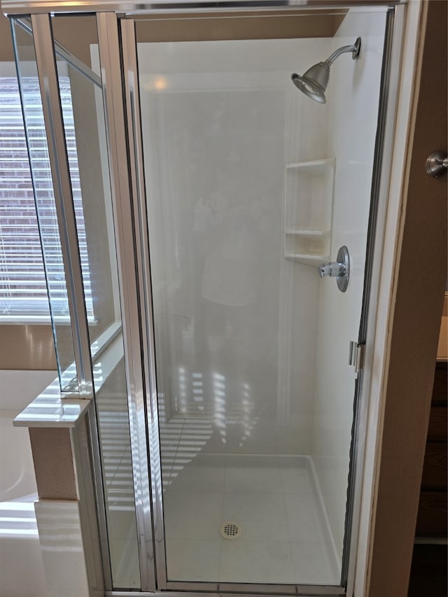 bathroom featuring plus walk in shower and tile patterned floors