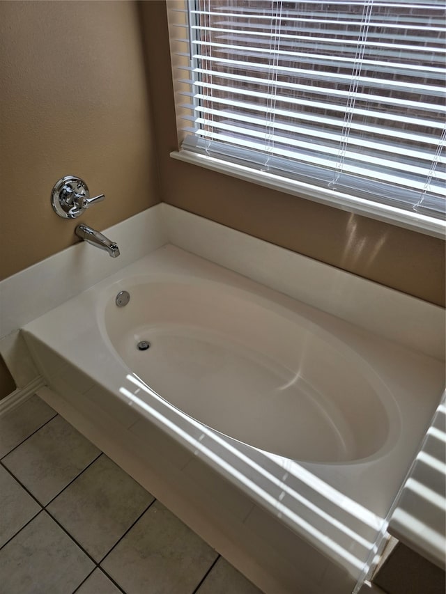 bathroom featuring tile patterned flooring and tiled bath