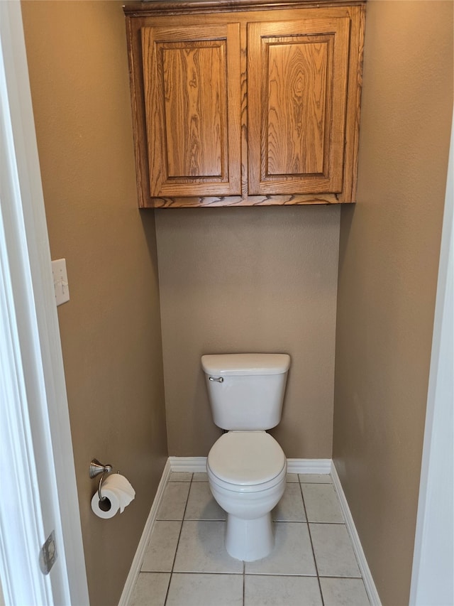 bathroom featuring toilet and tile patterned flooring