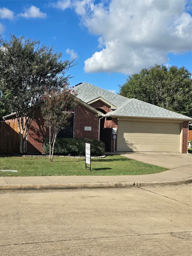 ranch-style house with a garage and a front yard