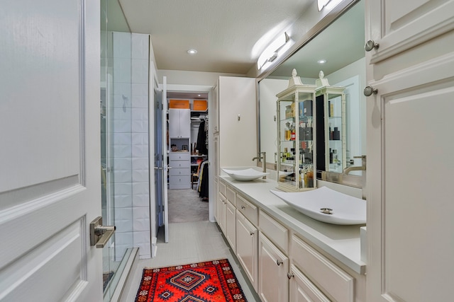 bathroom featuring vanity, tile patterned floors, and a shower with door