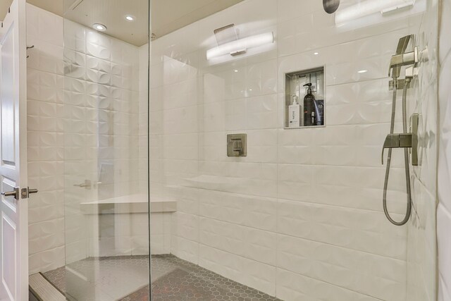 bathroom with tiled shower