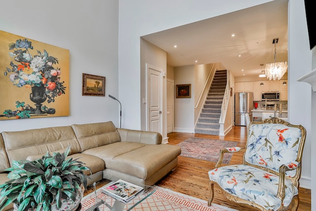 living room featuring wood-type flooring and a chandelier