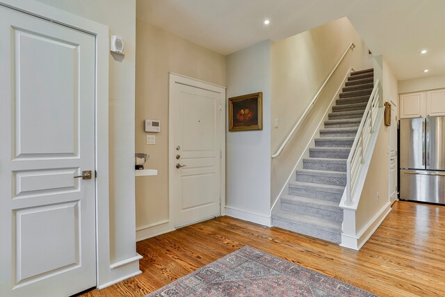 foyer entrance with light hardwood / wood-style floors