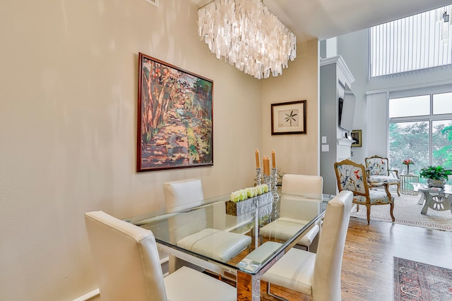 dining space with hardwood / wood-style flooring and a chandelier