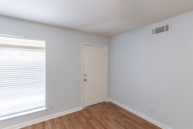 empty room with wood-type flooring