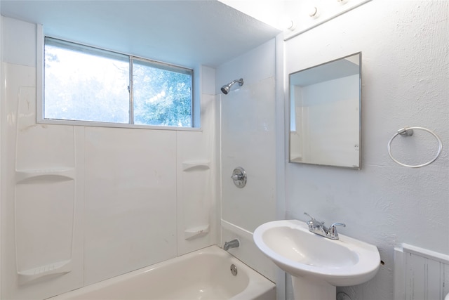 bathroom featuring radiator, sink, and shower / washtub combination