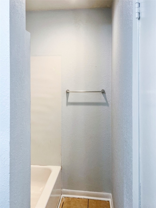 bathroom featuring tile patterned flooring and a bathtub