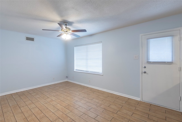 unfurnished room with ceiling fan, light hardwood / wood-style floors, and a textured ceiling