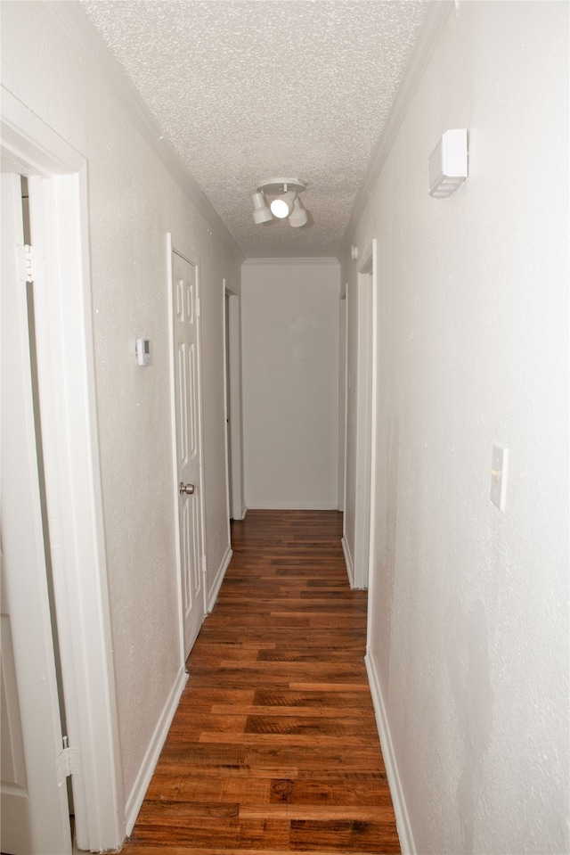 hallway featuring dark hardwood / wood-style floors and a textured ceiling