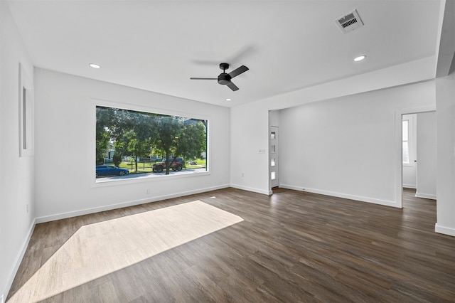 spare room featuring dark wood-type flooring and ceiling fan