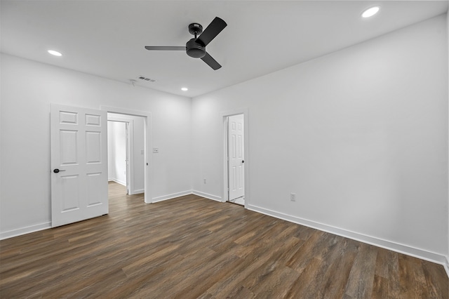 empty room with ceiling fan and dark hardwood / wood-style flooring