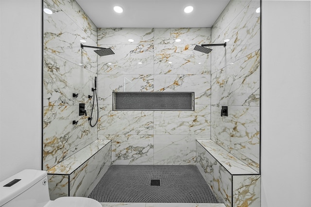 bathroom with tiled shower and toilet