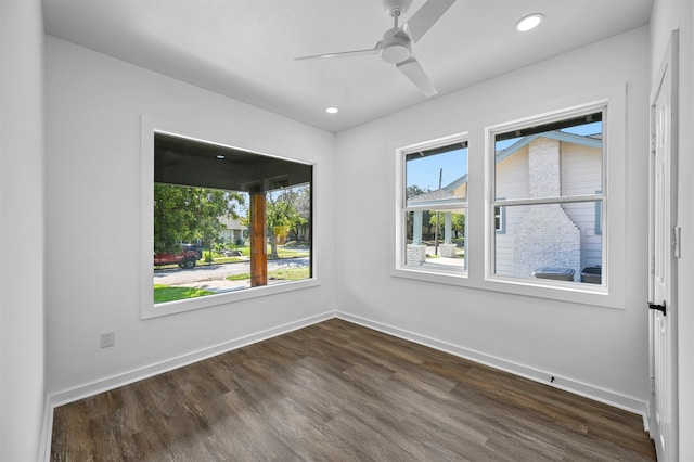 empty room featuring dark wood-type flooring and ceiling fan