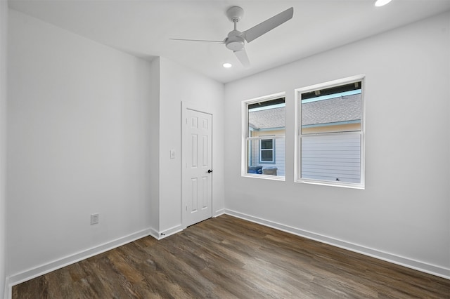 empty room with ceiling fan and dark hardwood / wood-style floors