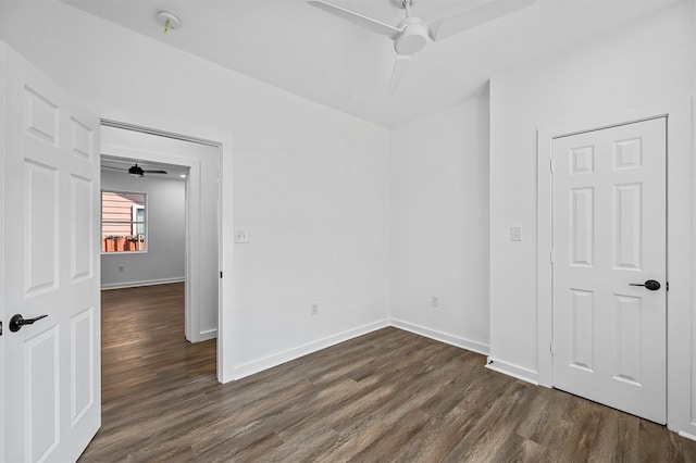 unfurnished room featuring dark wood-type flooring and ceiling fan