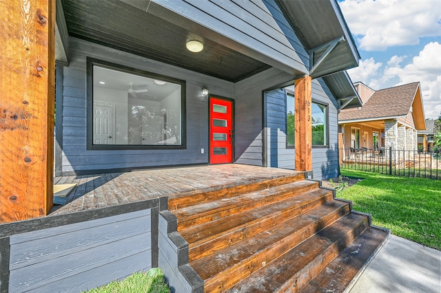 doorway to property with a lawn and covered porch