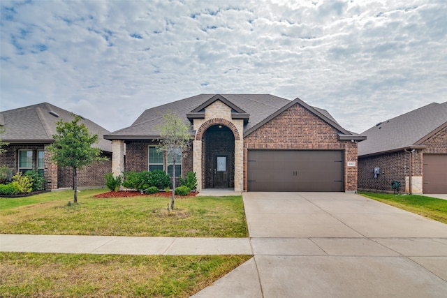 view of front of home with a garage and a front lawn