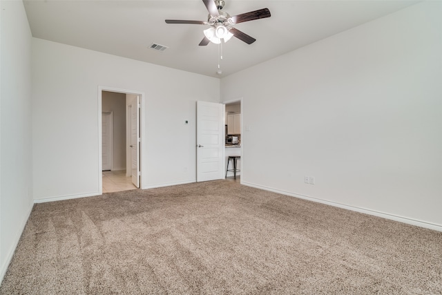 unfurnished room featuring ceiling fan and light carpet