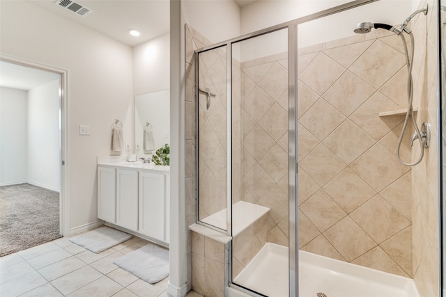 bathroom with tile patterned flooring, vanity, and a shower with shower door