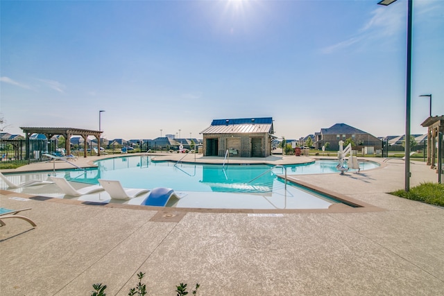 view of pool with a pergola and a patio area