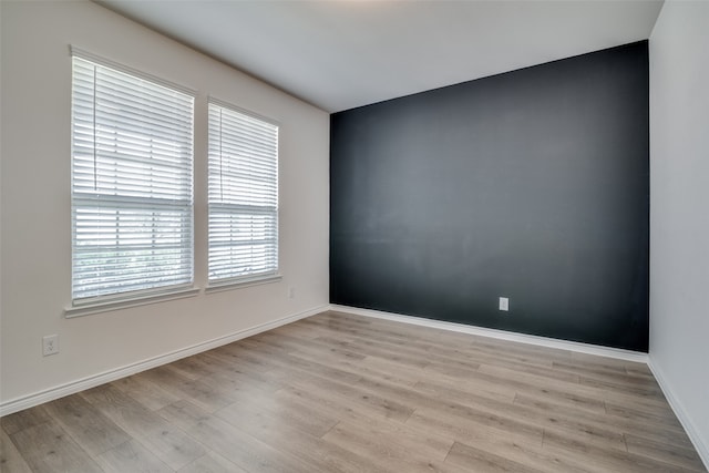 unfurnished room with light hardwood / wood-style floors