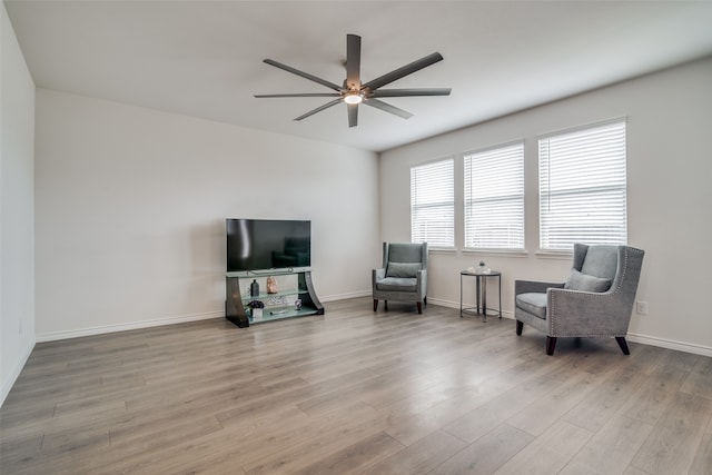 living area with light wood-type flooring and ceiling fan