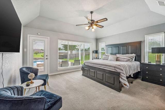 carpeted bedroom with lofted ceiling, ceiling fan, a raised ceiling, and access to exterior