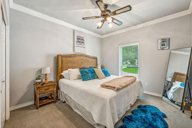 carpeted bedroom with a textured ceiling, ceiling fan, and ornamental molding