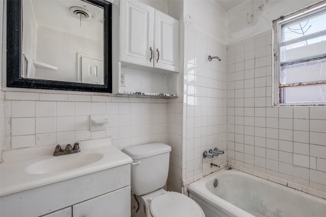 bathroom with toilet, shower / bath combination, visible vents, vanity, and tile walls