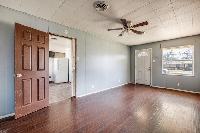 entrance foyer with a ceiling fan, visible vents, baseboards, and wood finished floors