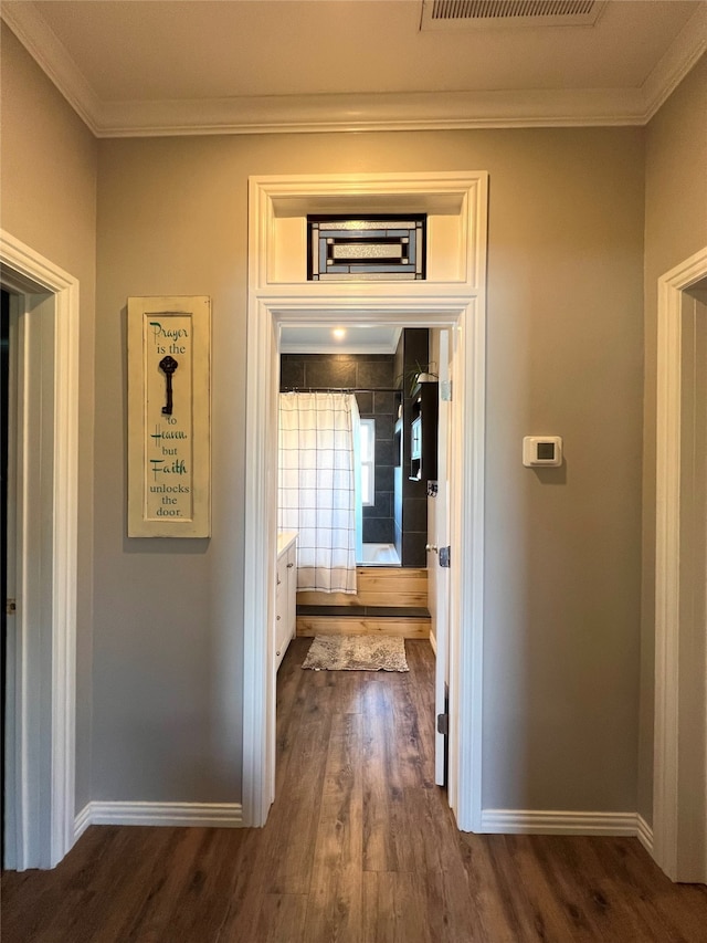 hall with crown molding and dark wood-type flooring