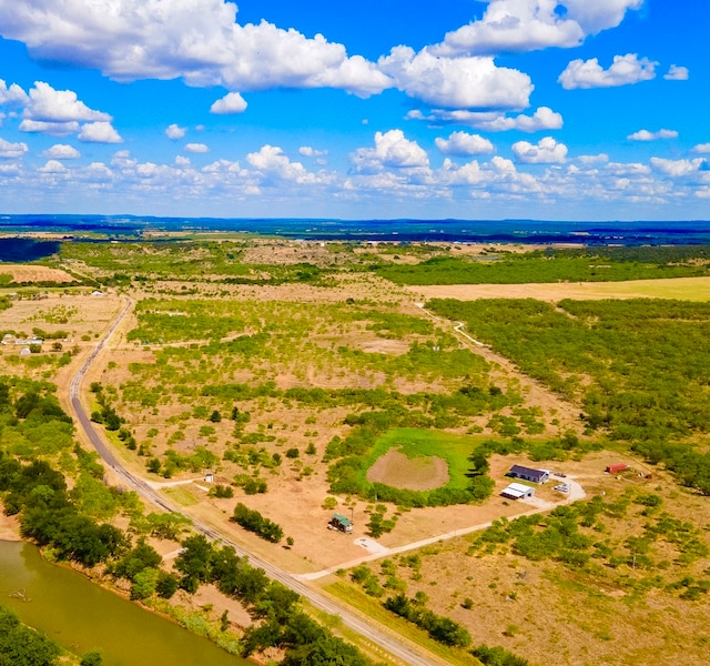 birds eye view of property with a water view and a rural view