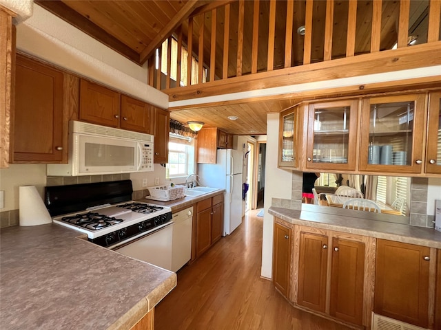 kitchen with white appliances, light hardwood / wood-style flooring, wood ceiling, sink, and lofted ceiling