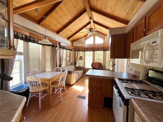 kitchen featuring decorative light fixtures, white appliances, lofted ceiling with beams, ceiling fan, and light wood-type flooring