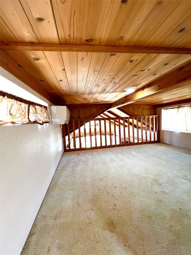 carpeted spare room featuring a wall mounted AC, wood ceiling, and beam ceiling