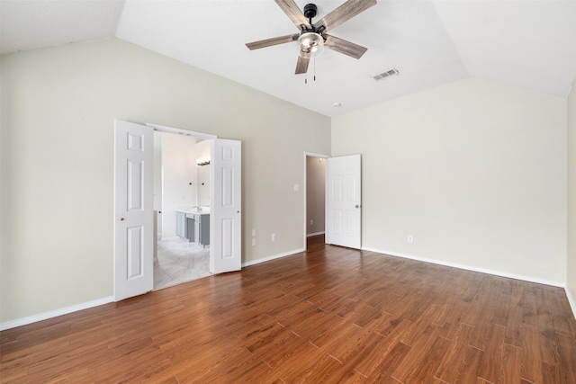 unfurnished bedroom with hardwood / wood-style floors, ceiling fan, and vaulted ceiling