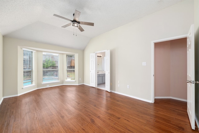 interior space with lofted ceiling, ceiling fan, and dark hardwood / wood-style floors