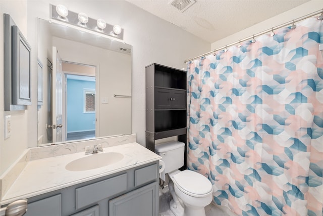 bathroom featuring vanity, toilet, a shower with curtain, and a textured ceiling