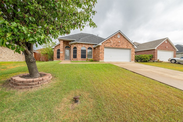 single story home featuring a garage and a front yard