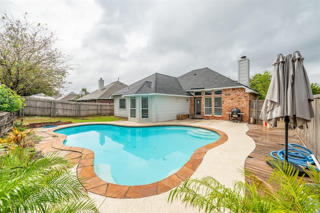 view of pool with a wooden deck