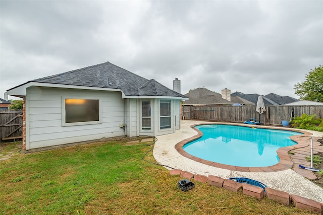 view of swimming pool with a lawn and a patio area