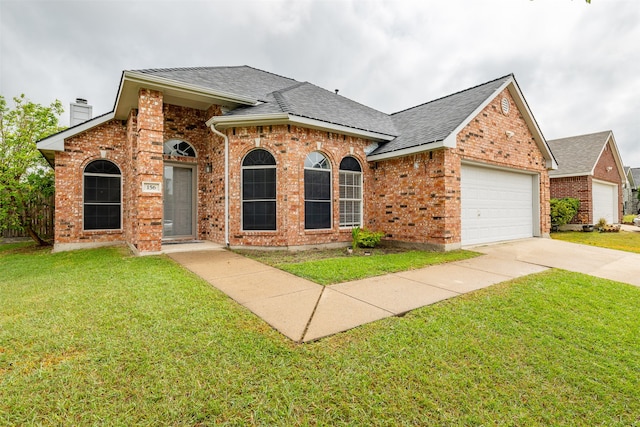 view of front of home with a garage and a front lawn