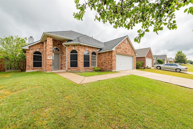 view of front facade with a garage and a front lawn