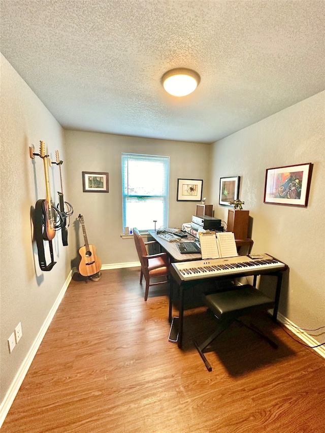 office area featuring a textured ceiling and light hardwood / wood-style flooring